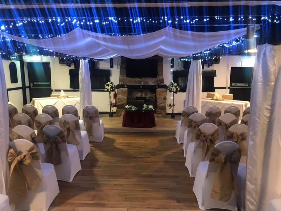 Wedding ceremony setup with decorated chairs.