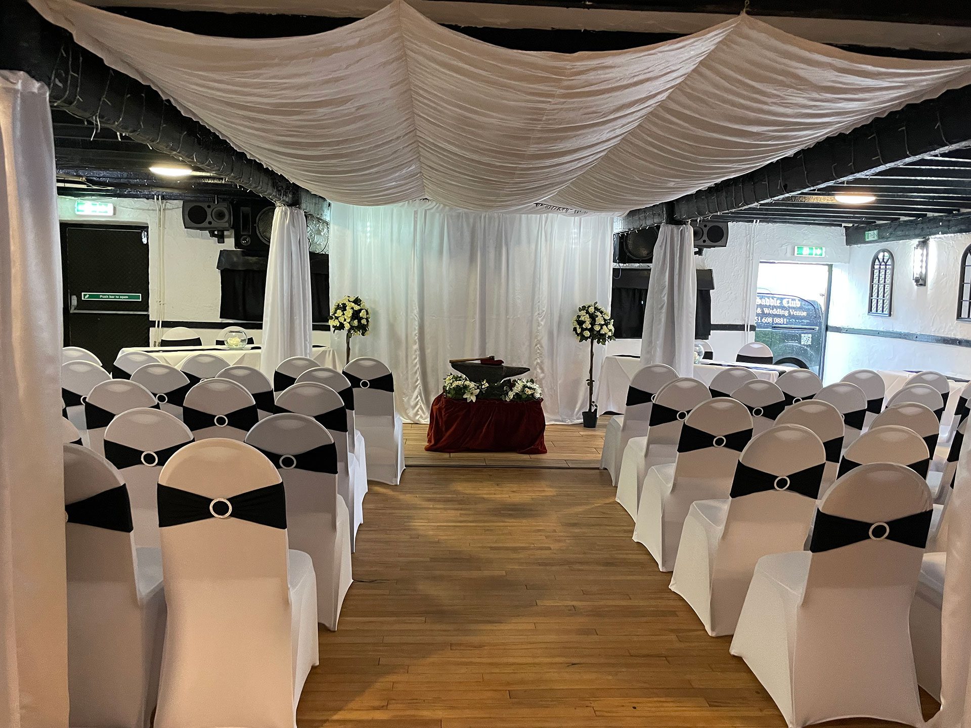 Wedding ceremony setup with white chairs.