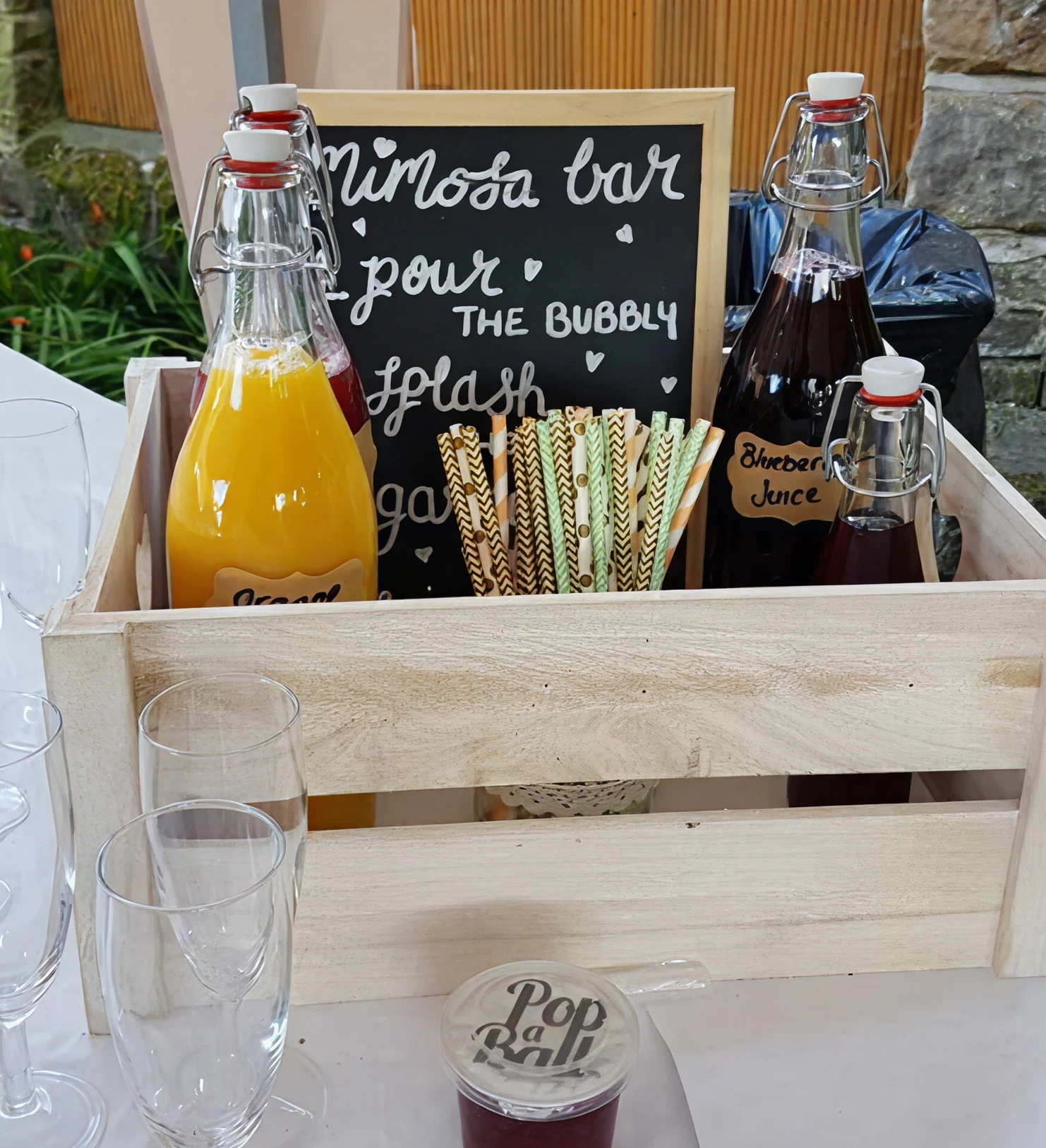 Mimosa bar setup with juices and glasses.