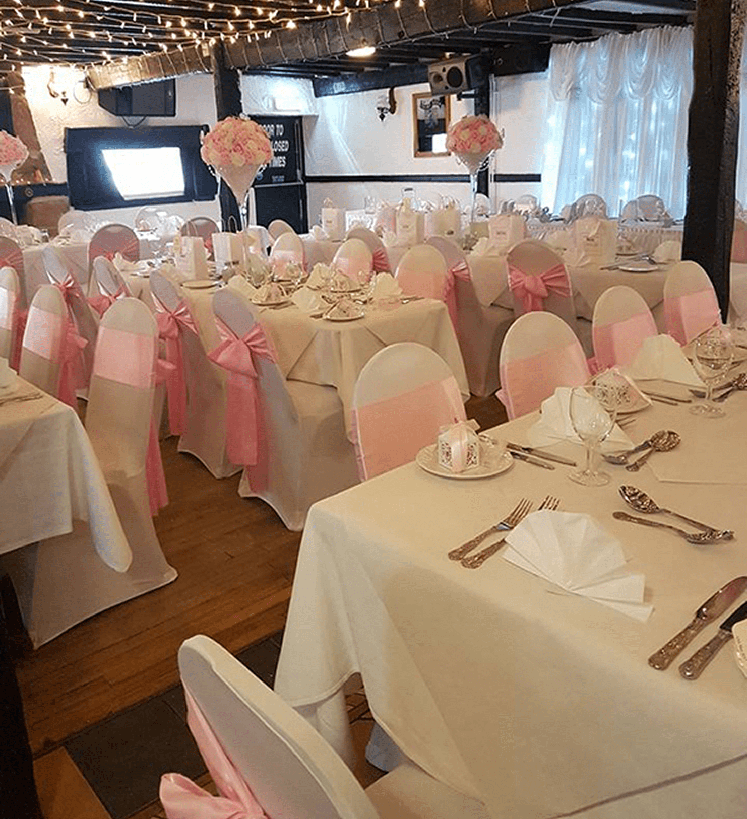 Elegant wedding reception with pink decorations.