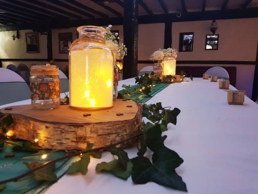 Rustic table decor with glowing lanterns.