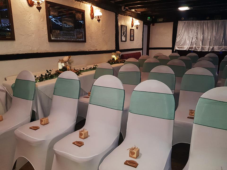 Chairs arranged for an indoor wedding ceremony.