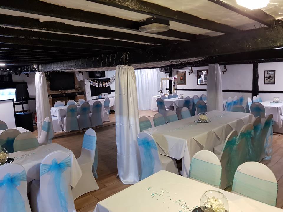 Decorated banquet hall with blue chair covers.