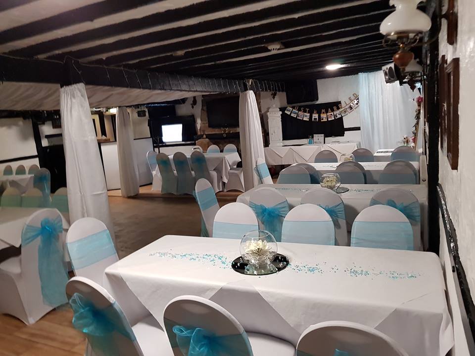 Decorated banquet hall with white and blue theme.