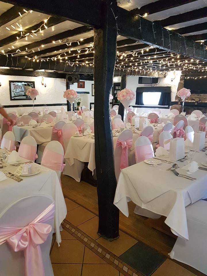 Wedding reception with pink and white decorations.