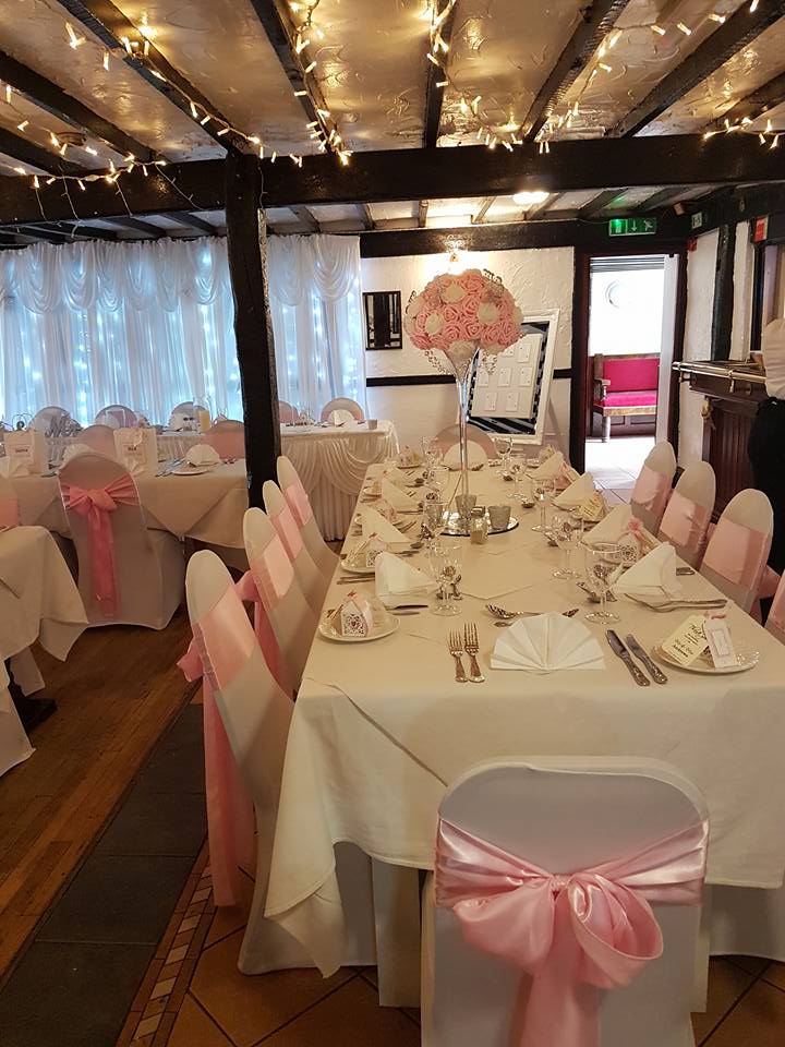 Elegant wedding reception with pink decorations.
