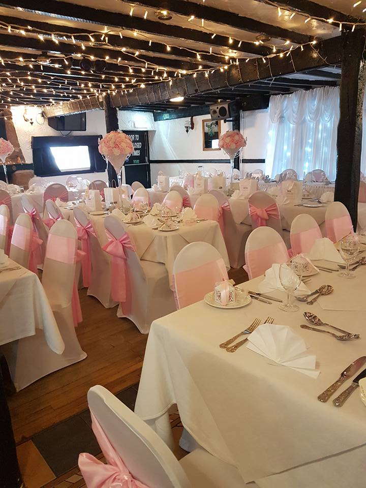 Elegant wedding reception with pink decorations.