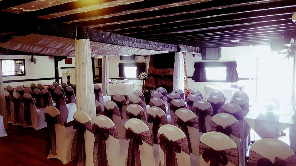 Wedding ceremony setup with decorated chairs.