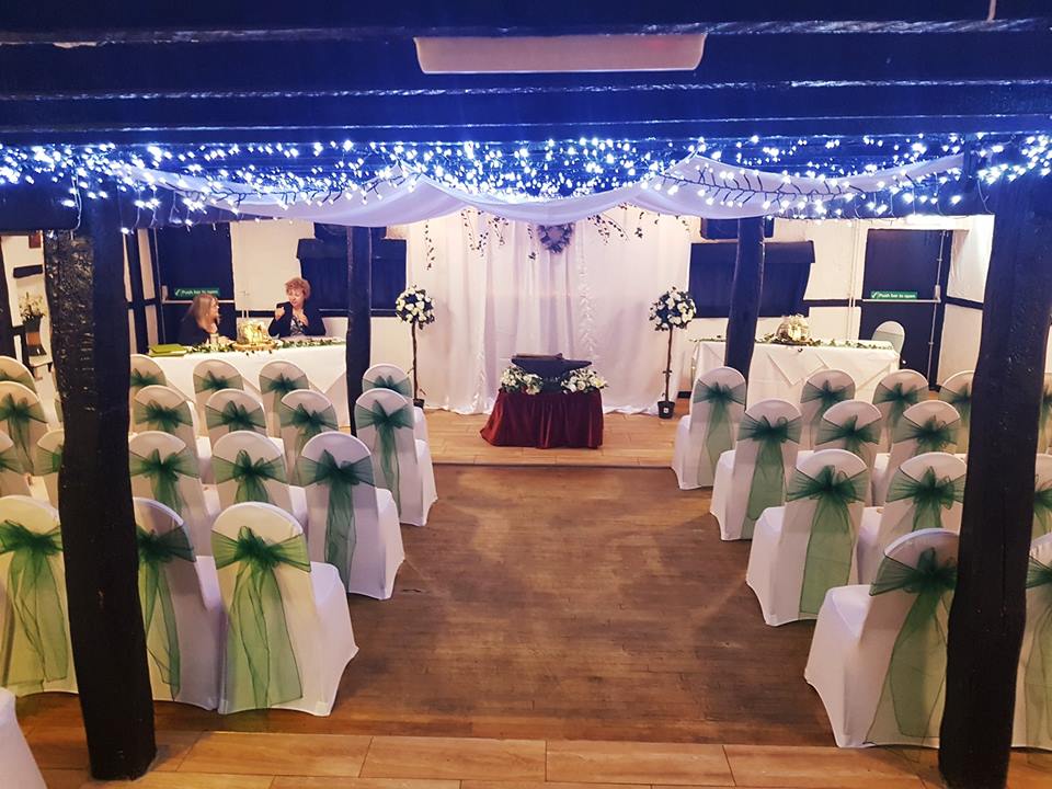 Wedding ceremony setup with decorated chairs.